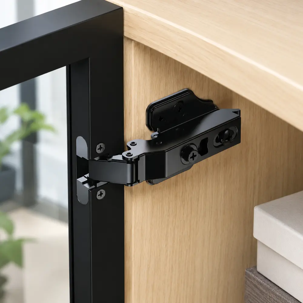 Close-up of a black-coated hinge arm showing the clip-on mechanism and adjustment screws, mounted on a dark frame.